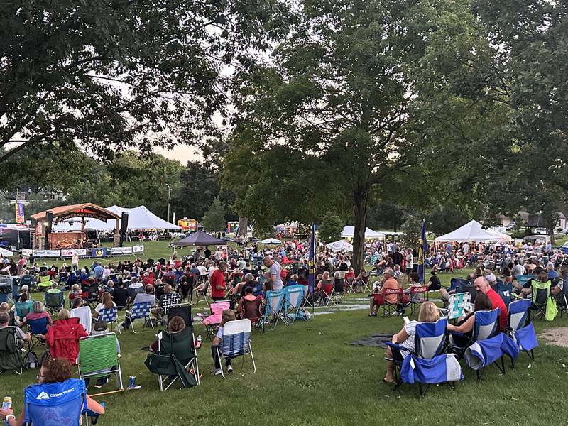 A large crowd watches the World Turning Band, a Fleetwood Mac tribute band perform underneath the Schweickert Pavilion during the Taste of the Illinois Valley festival on Saturday, Aug. 3, 2024 at Centennial Park in Peru.