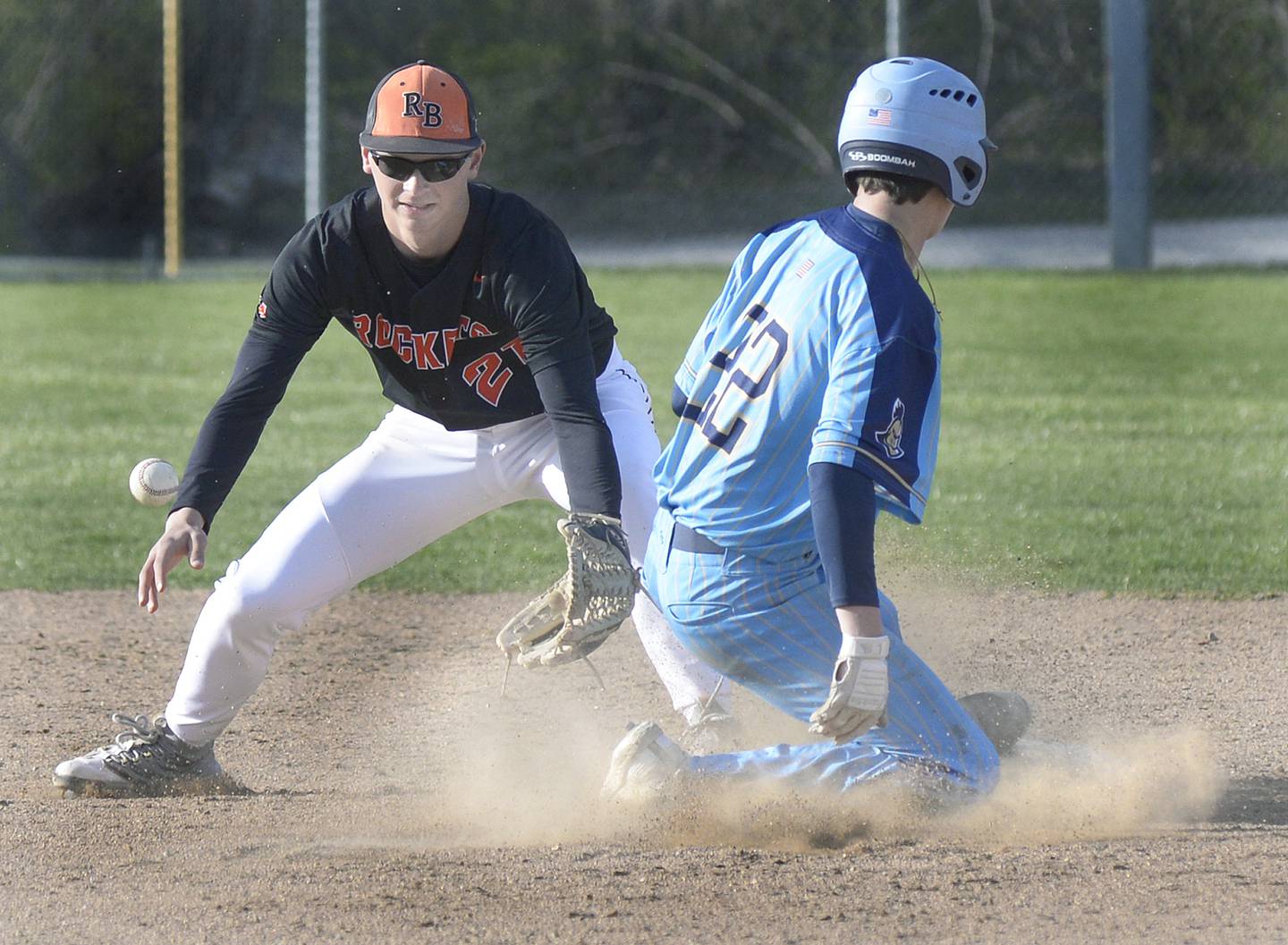 Marquette’s Griffin Dobberstein slides into second base beating the tag by Roanoke-Benson/Lowpoint-Washburn’s Evan Schumacher for a stolen base Tuesday at Masinelli Field.