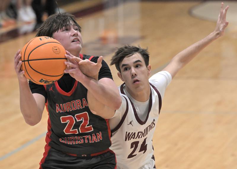 Wheaton Academy’s Kaleb Istvanik reaches for the ball held by Aurora Christian’s Jacob Baumann in a boys basketball game in West Chicago on Friday, Jan. 16, 2026.