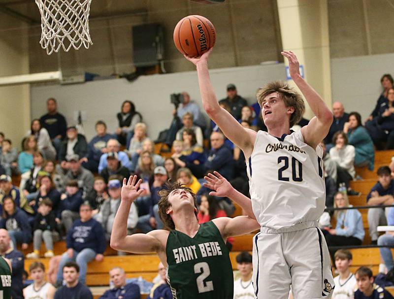 Marquette's Logan Nelson shoots a shot over St. Bede's Brendan Pillion in the Class 1A Regional semifinal on Wednesday, Feb. 22, 2023 at Midland High School.