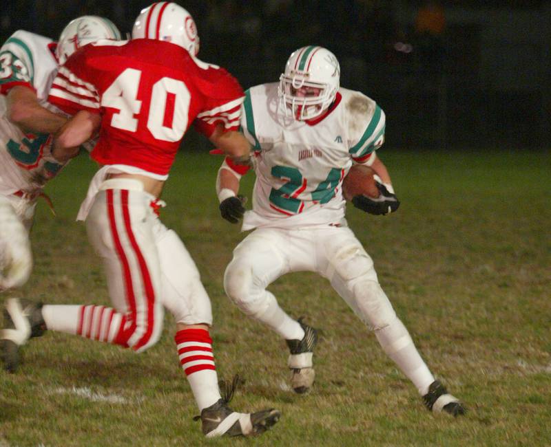La Salle-Peru's Wes Kostellic (24) readies to make a cut back as teammate Mark Koehler (33) makes a block on Ottawa's T.J. Ahearn (40) during the 2002 game at King Field.