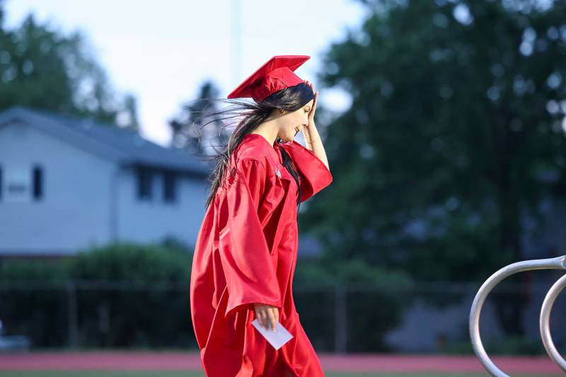 Graduate Bailee Blanchette holds her hat in the wind as she approaches the stage during the Bradley-Bourbonnais Community High School commencement ceremony on Thursday, May 21, 2026.
