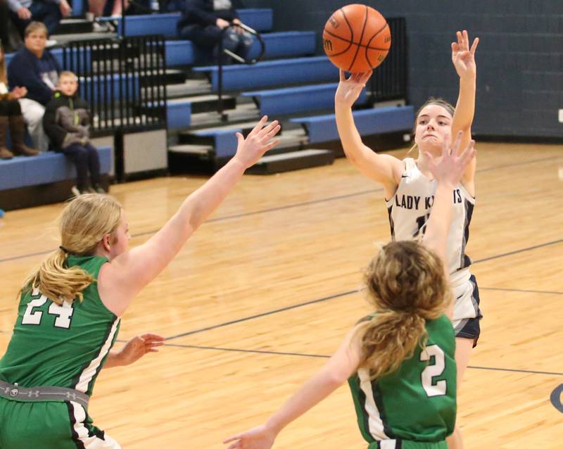Fieldcrest's Haley Carver shoots a three point basket to send the game to overtime over Eureka's Ella Ausmus and Reagan Linder on Monday, Jan. 9, 2023 at Fieldcrest High School.