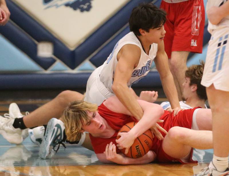 Hall's Wyatt West falls on a loose ball as Bureau Valley's Corban Chhim arrives late to the action on Friday, Jan. 19, 2024 at Bureau Valley High School.