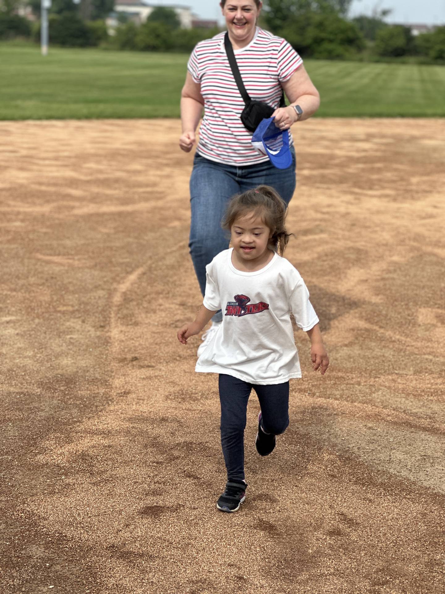 Algonquin Area Youth Organization Twisters baseball player Braylee running the bases with her mom during the team's first game on July 13, 2025.
