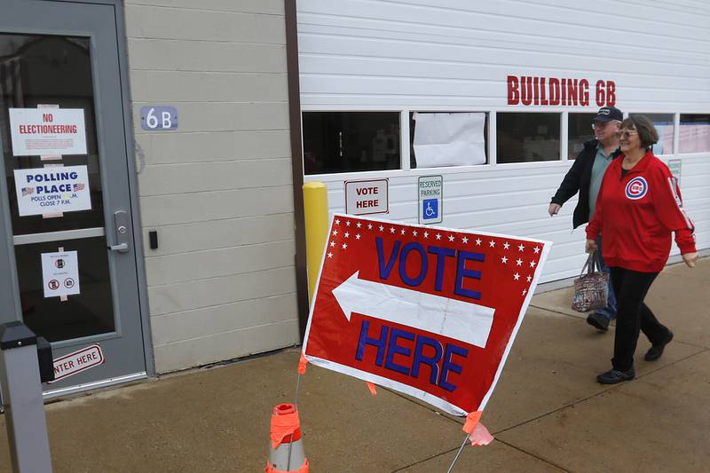 Bill and Pam Hanson walk into the Algonquin Township Building in Cary on Thursday, March 14, 2024, to vote.