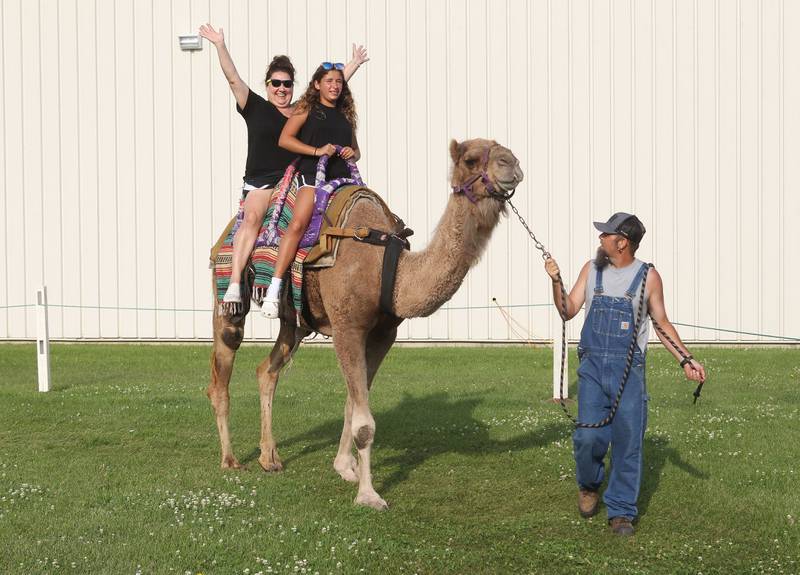 Dana Alvarez, of Gurnee and her daughter, Olivia, 13, ride a camel as John Craig, animal specialist, leads the way during the Lake County Fair at the Lake County Fairgrounds on July 28th in Grayslake.  
Photo by Candace H. Johnson for Shaw Local News Network