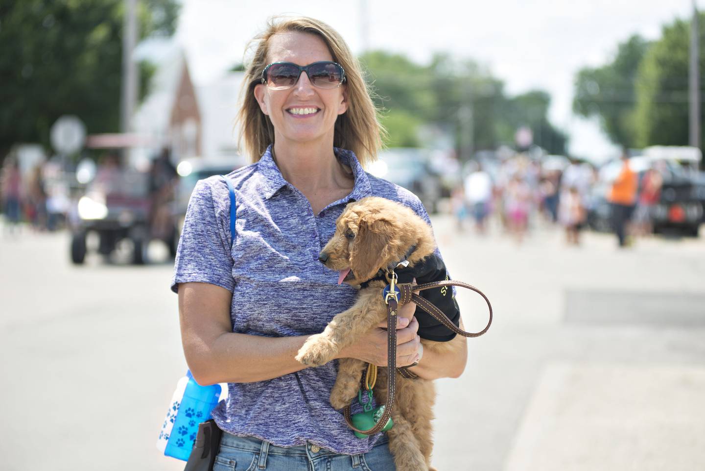 Kim Cavazos, jail administrator at Whiteside County, introduces Copper the county's new comfort dog to people in Tampico Sunday during the town's parade.