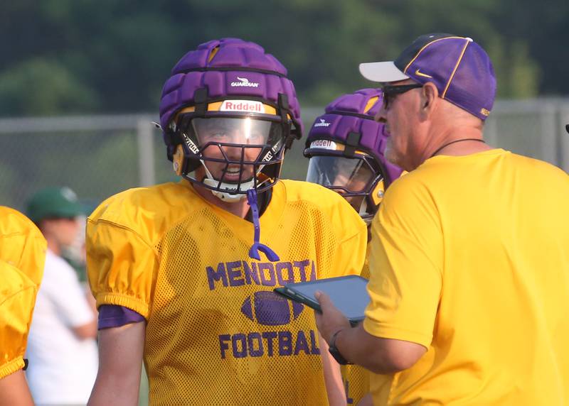 Mendota quarterback Aden Tillman talks to head coach Jim Eustice between plays during a joint practice on Thursday, July 31, 2025 at Mendota High School.