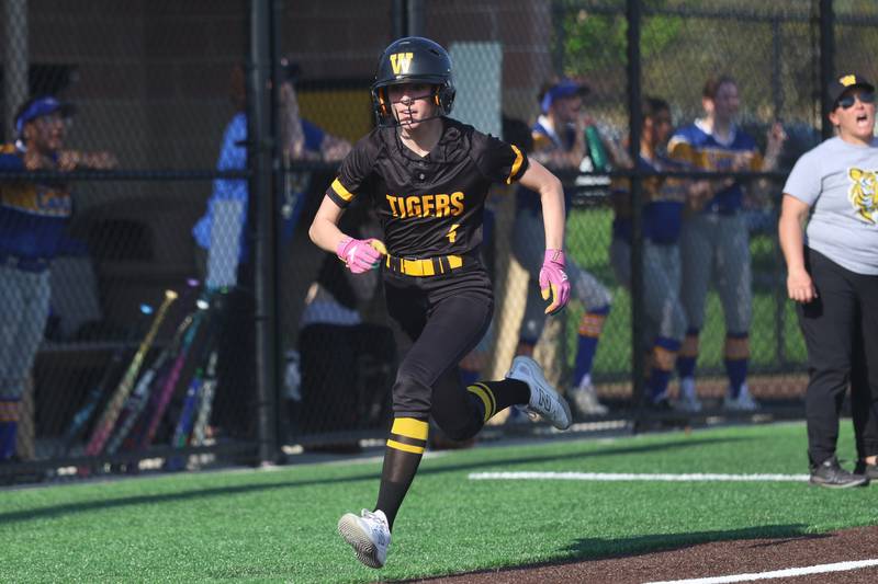 Joliet West’s Ella Featherston sprints home on an inside the park home run against Joliet Central on Wednesday, April 22, 2026 in Joliet.