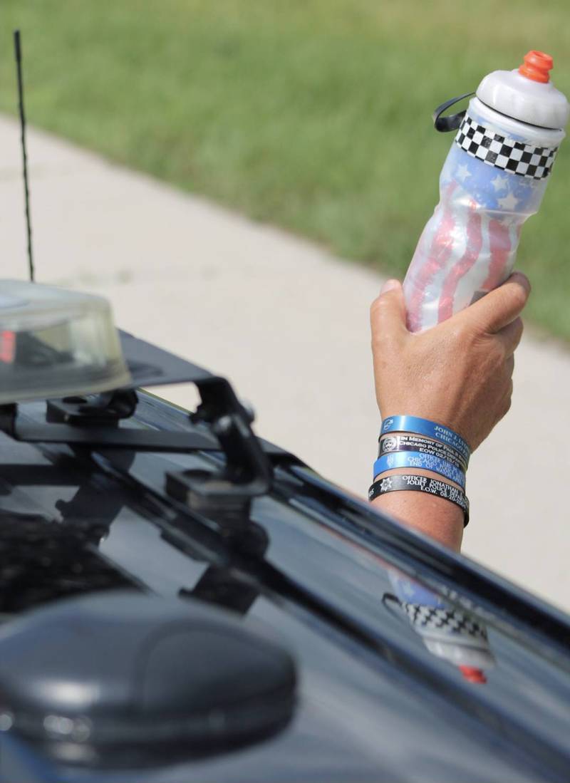 Bracelets memorializing fallen police officers are worn by participants in the 2025 Cycle Across Illinois, a four-day charity bike ride to honor police officers killed in the line of duty and raise funds for their families.