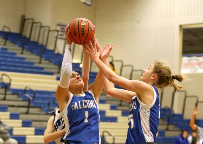 Wheaton North’s Zoey Bohmer (left) and Brigette Noyes (right) go after the rebound during a game at Geneva on Friday, Dec. 22, 2023.