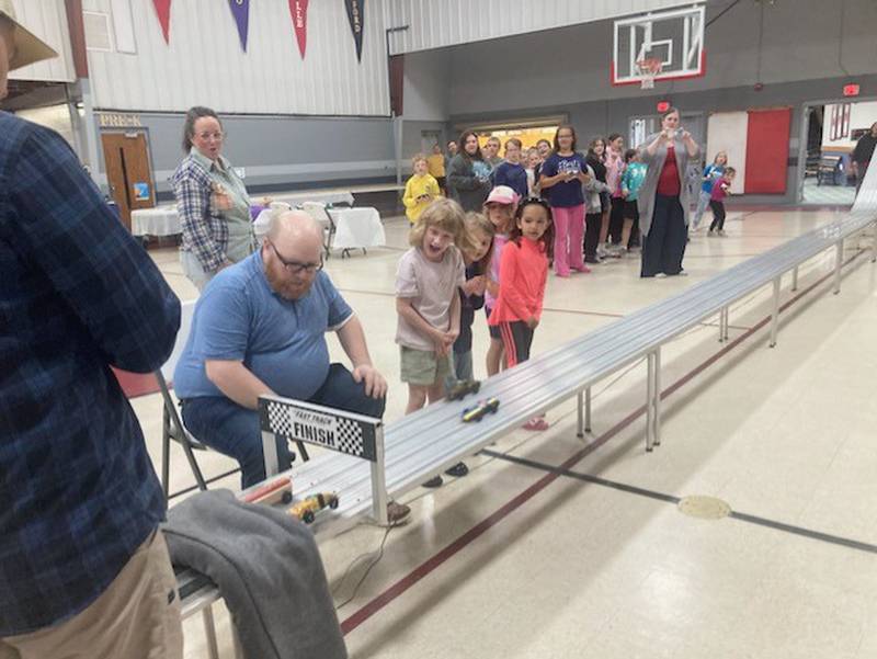 Matt. Eggers checks the finish line during the AWANA Pinewood Derby Night at Princeton Bible Church.