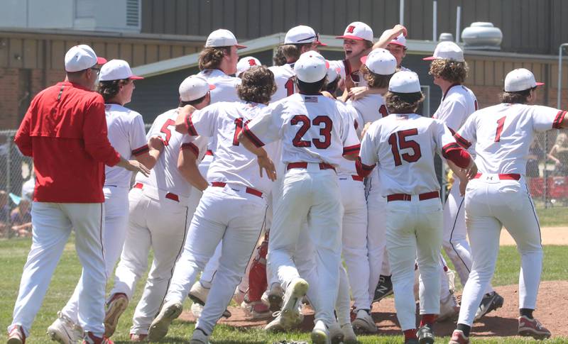 Members of the Hall baseball team celebrate on the mound after defeating Sherrard during the Class 2A Sectional final game on Saturday, May 27, 2023 at Knoxville High School.