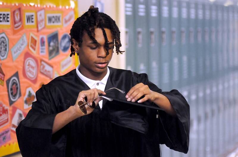 Jason Brown fixes his tassel Thursday, May 12, 2022, before the Haber Oaks Campus graduation in the courtyard of Crystal Lake South High School.