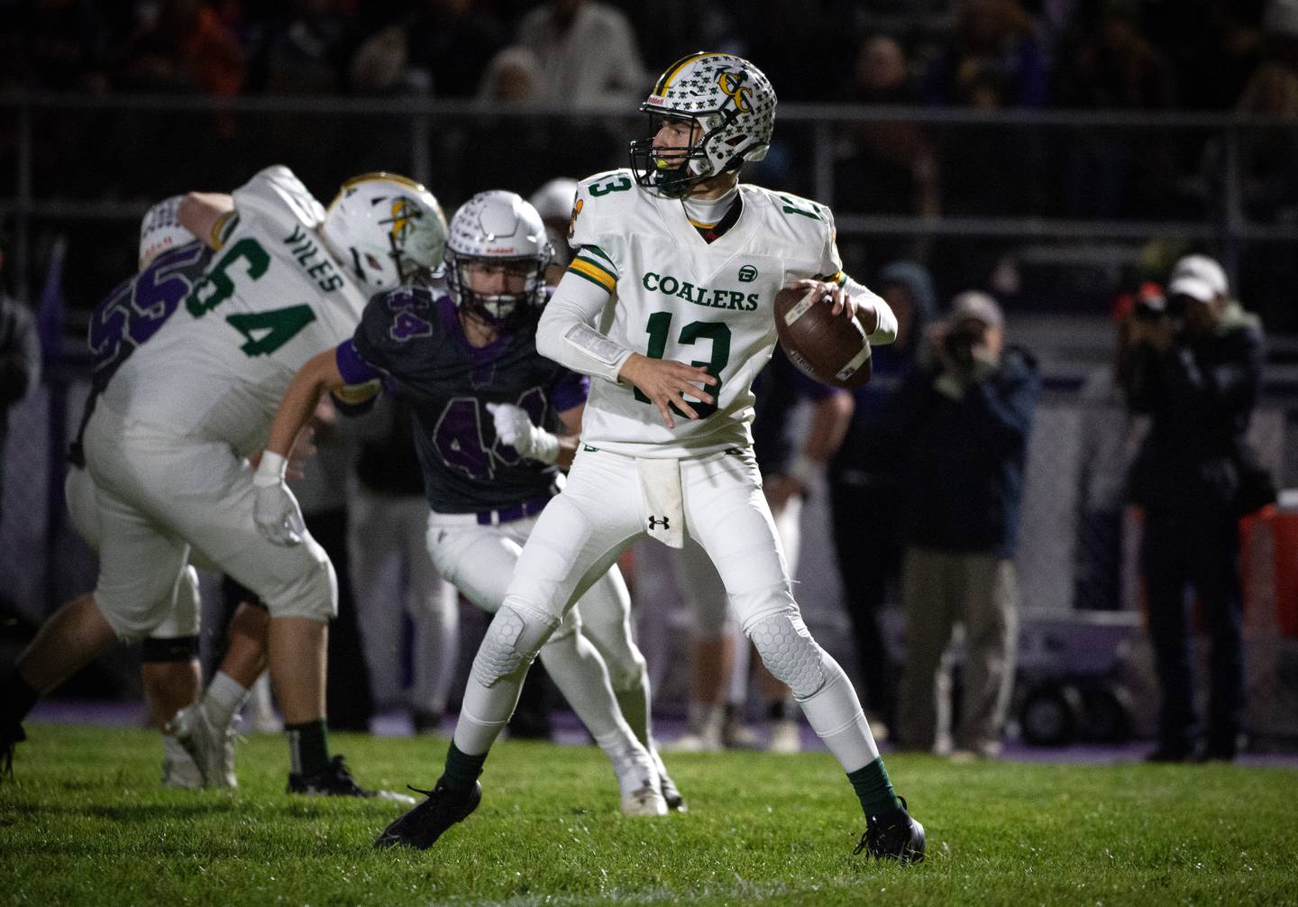 Coal City's Connor Henline drops back to pass in a game against Wilmington on Friday, October 24, 2025.