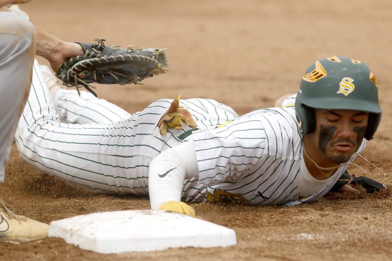 Crystal Lake South's Yandel Ramirez dives back to first base during the IHSA Class 3A Grayslake Central Sectional Championship baseball game against Cary-Grove on Saturday, June 7, 2025, at Grayslake Central High School.