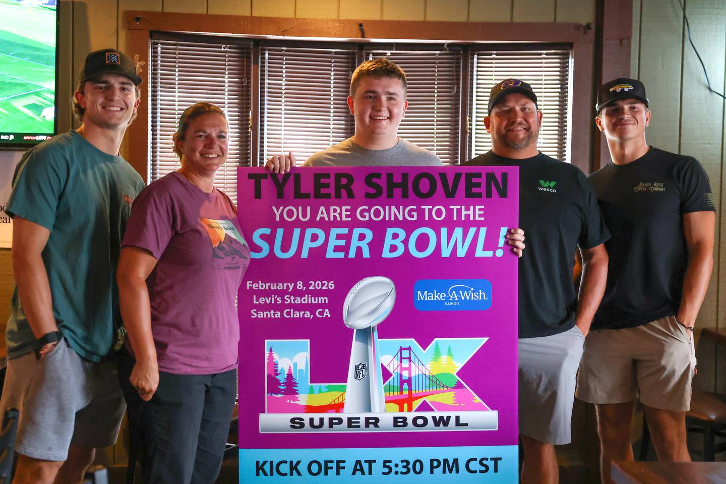 Tyler Shoven, center, stands with his parents, Sarah and Jason, next to him and his brothers Jacob, left, and Luke, right, after being surprised with a trip to the Super Bowl by Make-A-Wish Illinois volunteers last week as his family dined at Sammy's in Bourbonnais.
The 2025 Clifton Central graduate will celebrate the third anniversary of his heart transplant in February along with traveling to California for the big game.