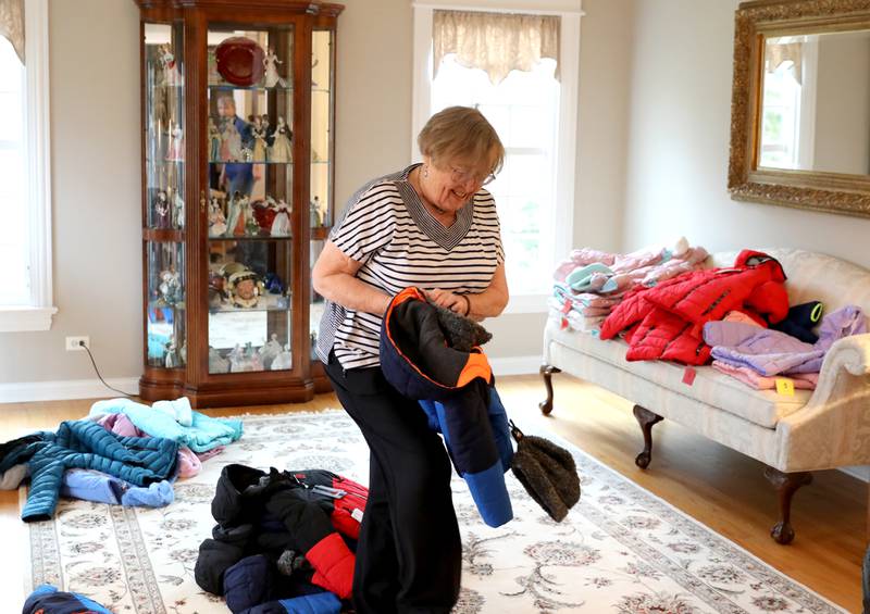 Volunteer Jeanne Humke of St. Charles gathers children’s winter coats to be donated to the Salvation Army, Lazarus House and area schools.