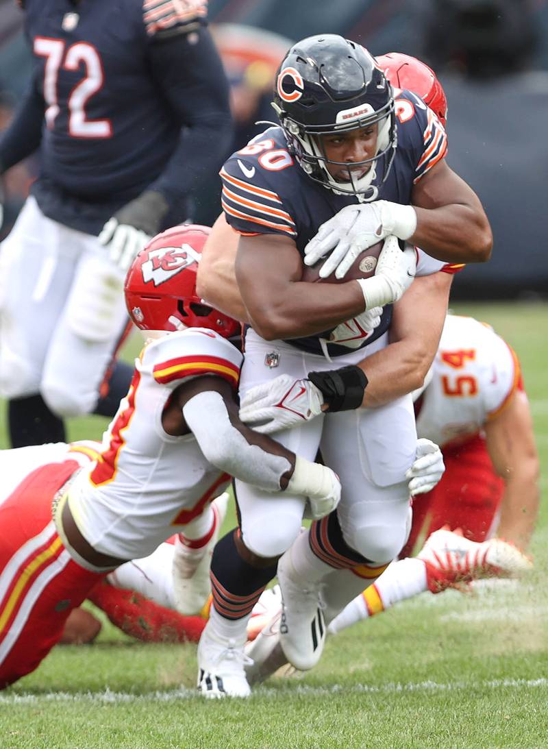 Chicago Bears running back De'Montre Tuggle tries to pull away from Kansas City Chiefs safety Nazeeh Johnson during their preseason game Aug. 13, 2022, at Soldier Field in Chicago.