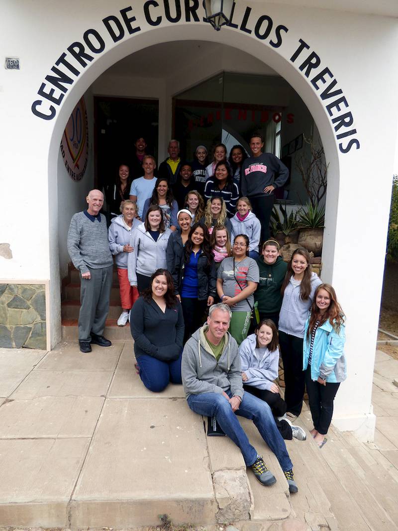 The 2014 Diocese of Joliet youth mission team to Bolivia. Natalie Bayci, who's coordinated and participated in 18 trips in 20 years, is standing under the archway, second from the left.