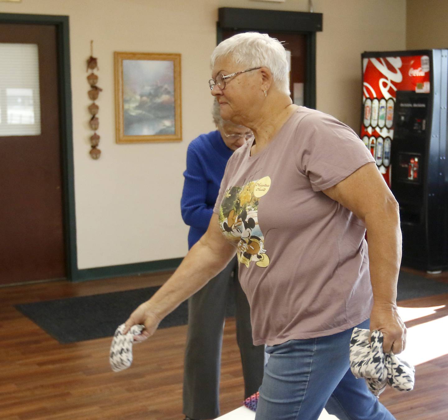 Carol Toussaint, of Johnsburg, tosses a bag while playing bags with Marie Wasil, of McHenry, Tuesday, Nov. 1, 2022, at the senior center in McHenry Township. About 70 million Social Security recipients will see a raise in their benefits to help keep up with inflation.