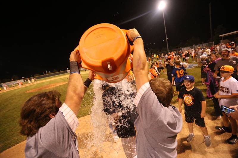 Illinois Valley Pistol Shrimp team owner and field manager John Jakiemiec gets drenched by gatorade from players after winning the Prospect League championship on Wednesday, Aug. 7, 2024 at Schweickert Stadium in Peru.