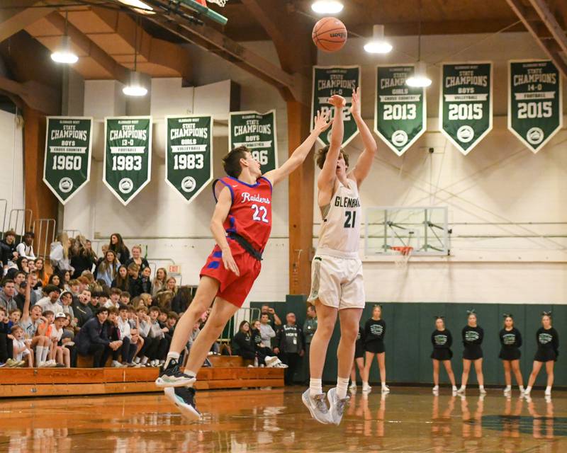 Glenbard West's Bryce Huff (21) makes a three point shot during the second quarter while being defended by Glenbard South's Ben Zima (22) on Monday Nov. 20, 2023, during The district 87 Invite held at Glenbard West.