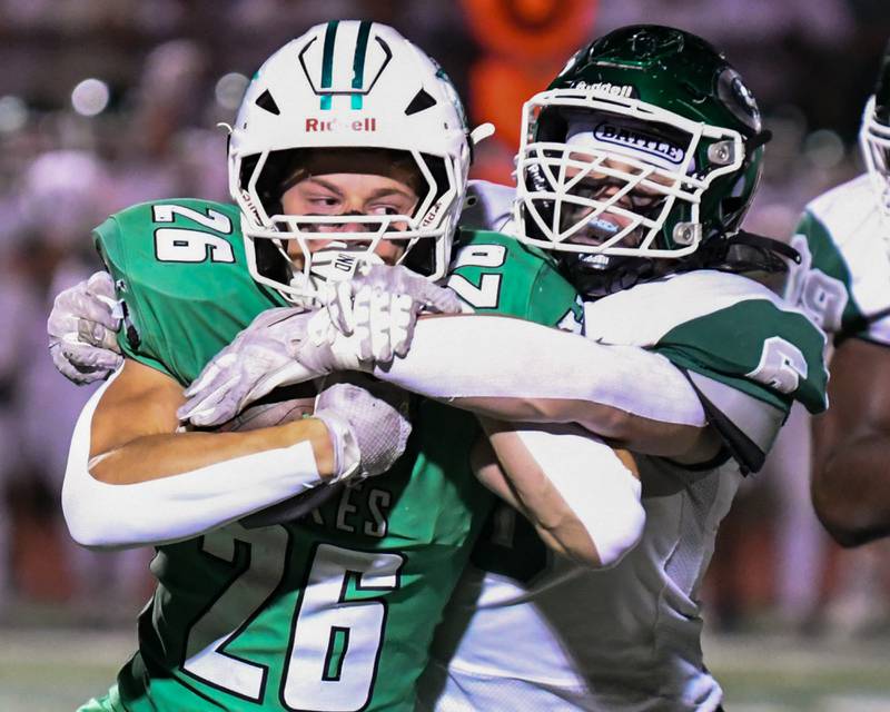 York's Henry Duda (26) gains some yards while caring the ball before being tackled by Glenbard West's Scott Segebarth (6) during the game on Friday Oct. 17, 2025, held at York High School.
