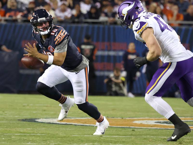 Chicago Bears quarterback Caleb Williams avoids the pass rush of Minnesota Vikings linebacker Andrew Van Ginkel during their game Monday, Sept. 8, 2025, at Soldier Field in Chicago.