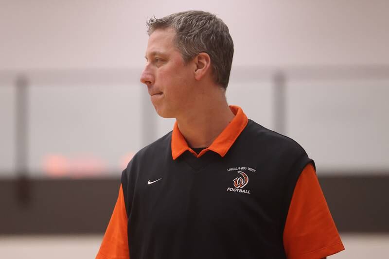 Lincoln-Way West head coach Tanner Mitchell walks the sidelines against Lincoln-Way East.