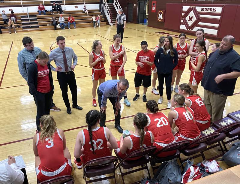 Ottawa girls basketball head coach Brent Moore (center) talks things over with his team during a timeout Monday, Feb. 12, 2024, at the Class 3A Morris Regional in Morris.