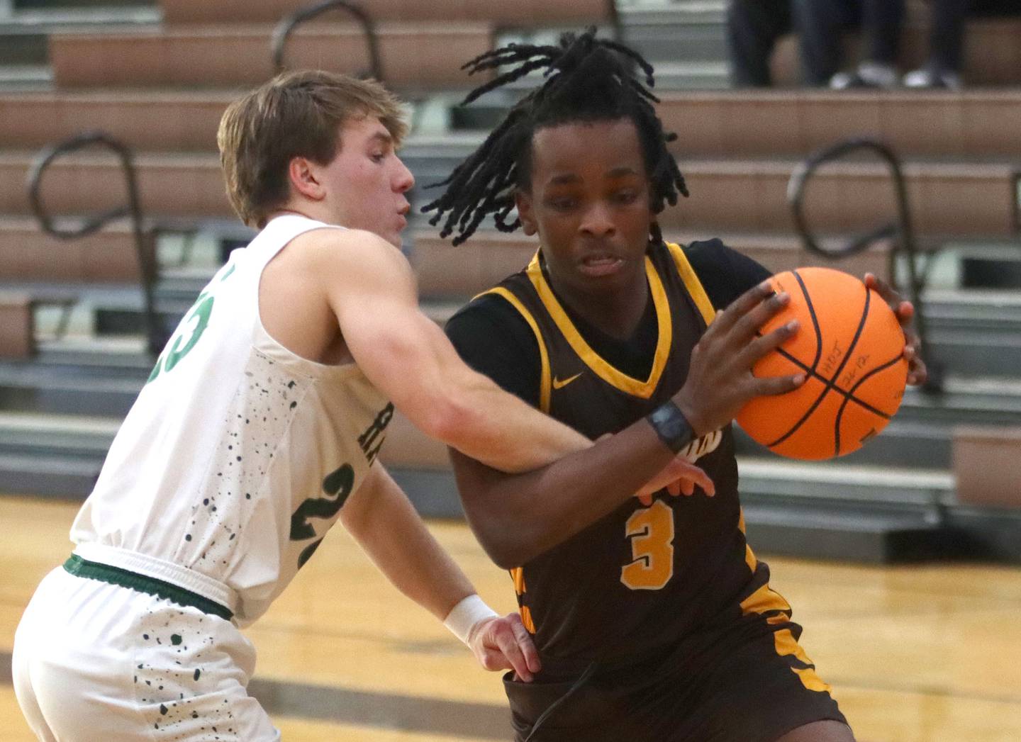 Jacobs’ Malachi Bell, right, drives as Grayslake Central’s Carson Woods defends in varsity boys basketball Hinkle Holiday Classic action on Tuesday, Dec. 23, 2025, at Jacobs High School in Algonquin.