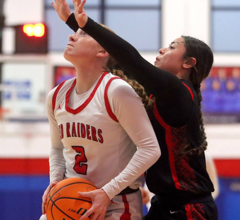 Huntley’s Avery Suess, left, gets past Mundelein’s Dulce Hernandez in varsity girls basketball Komaromy Classic tournament  action on Tuesday, Dec. 30, 2025, at Dundee-Crown High School in Carpentersville.