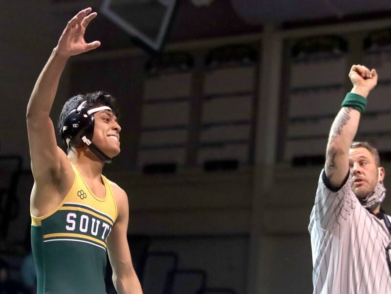 Crystal Lake South’s Alex Flores is declared the winner by official Blake Vermillion, right, after Flores’ match against McHenry’s Justin Karcz at 138 pounds during varsity wrestling at Crystal Lake Thursday night.