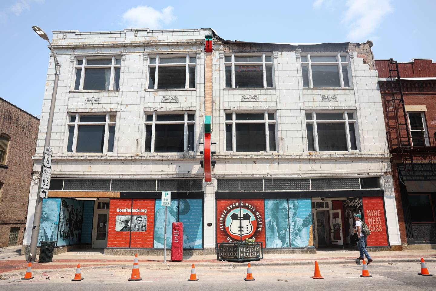 The damaged awning of the Illinois Rock and Roll Museum on Route 66 is removed and safety cones are put out on Tuesday, July 23, 2024 after high winds damaged the building on Sunday July, 14.