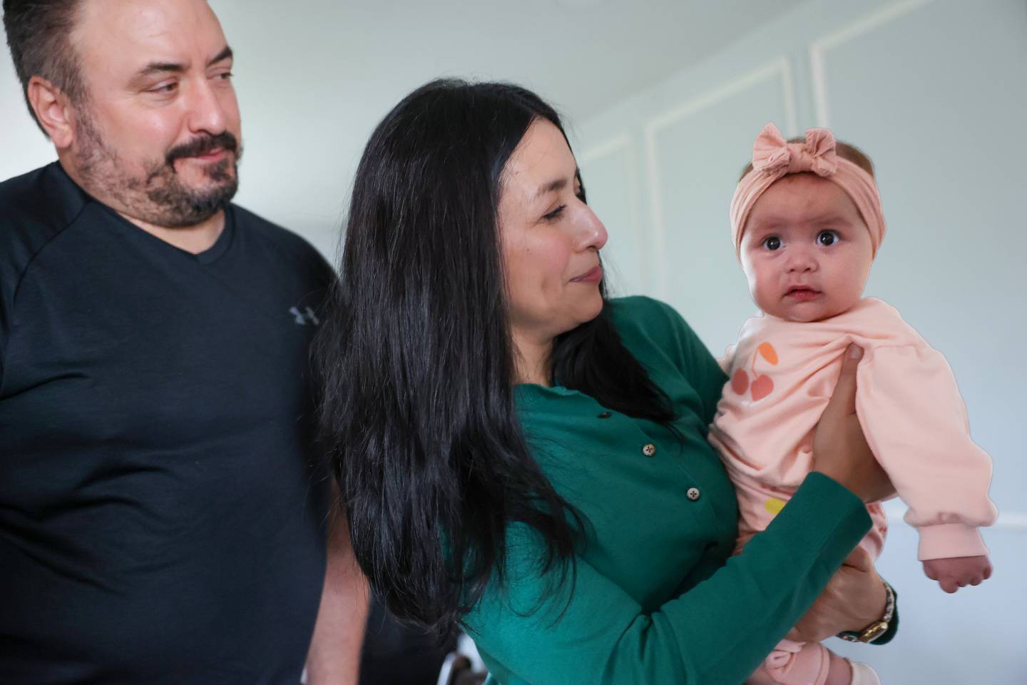 Anabel and Jimmy Horchem lovingly look toward their 5-month-old daughter, Amelia, in their Aroma Township home on May 6, 2026, where they survived the March 10 tornado by sheltering in the bathtub, using their bodies to cover Amelia.