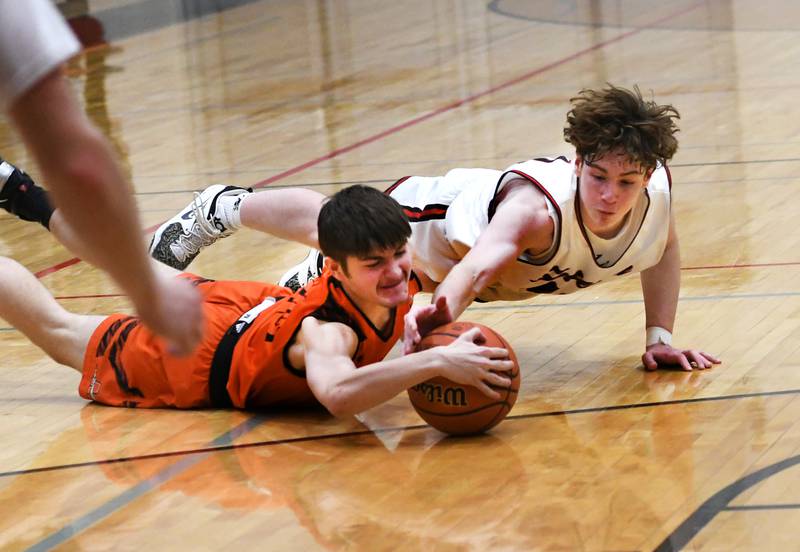 Forreston's Brendan Greenfield (top) and Milledgeville's Khrystiyan Dunn dive after a loose ball during a Friday, Jan. 27 NUIC game in Forreston.