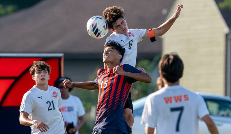 Wheaton Warrenville South's Chase Kedzior (6) goes up for a header over Oswego’s Alexander Mathew (15) during a soccer match at Oswego High School on Thursday, Aug 25, 2022.