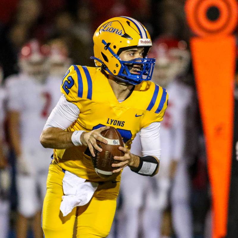 Lyon's Dom Pisciotte (12) looks for an open receiver during Class 8A quarterfinal football game between Naperville Central at Lyons on Friday, Nov 15, 2024  in Western Springs.
