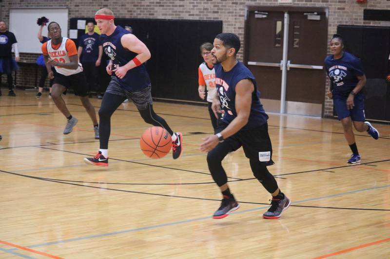 Ray Hernandez (center) leads a fast-break attempt Dec. 4, 2023 during the Guns and Hoses Basketball Game put on at Huntley Middle School in DeKalb.