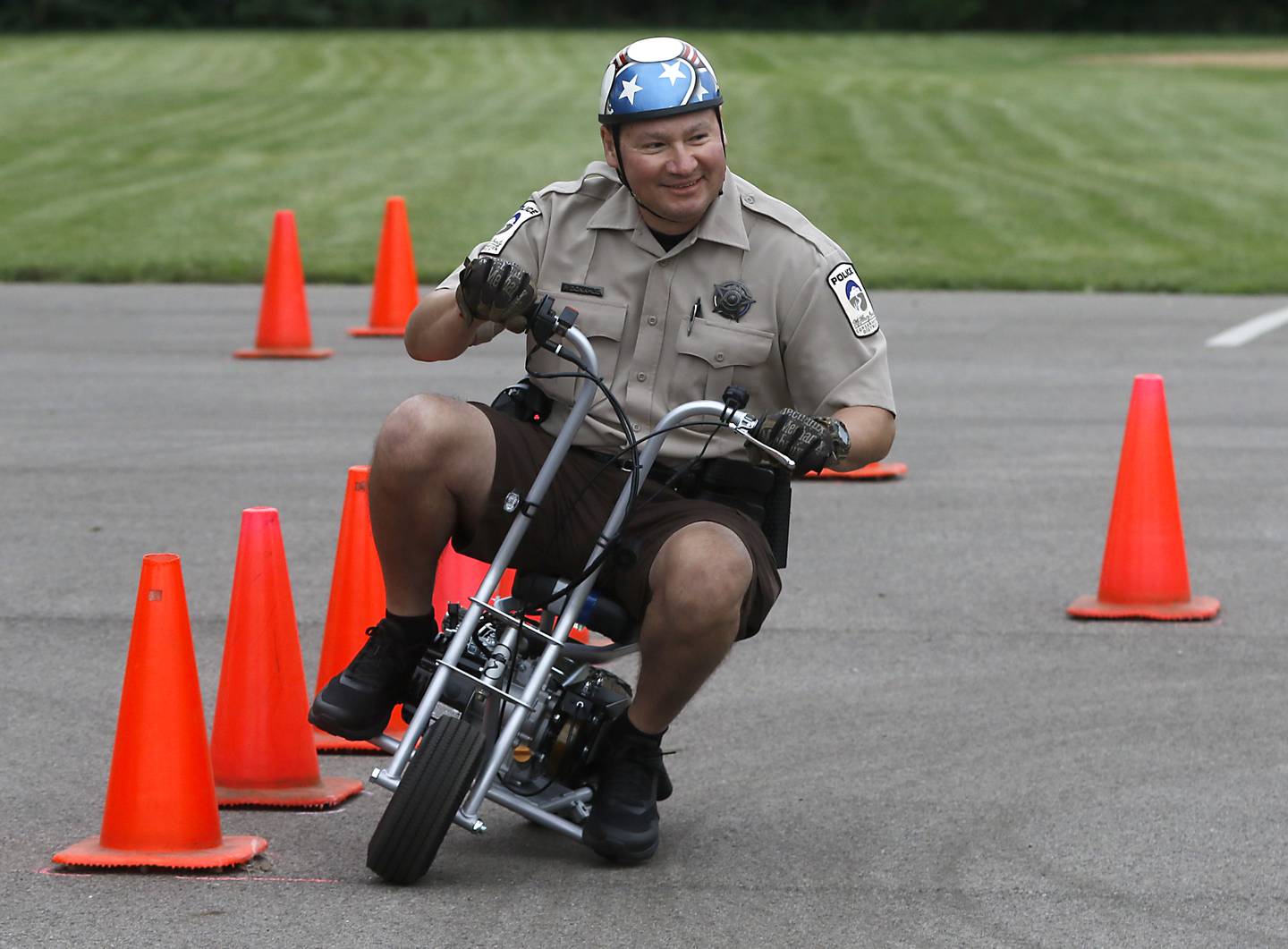 McHenry County Conservation District Police Patrick Donahue rides “Mo” as he has some fun while performing in the motorcycle demonstration during a National Night Out event Tuesday, Aug. 6, 2024, at Petersen Park in McHenry.