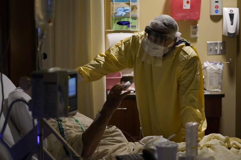 Dr. Shane Wilson performs rounds in a portion of Scotland County Hospital set up to isolate and treat COVID-19 patients Tuesday, Nov. 24, 2020, in Memphis, Mo. The tiny hospital in rural northeast Missouri is seeing an alarming increase in coronavirus cases.