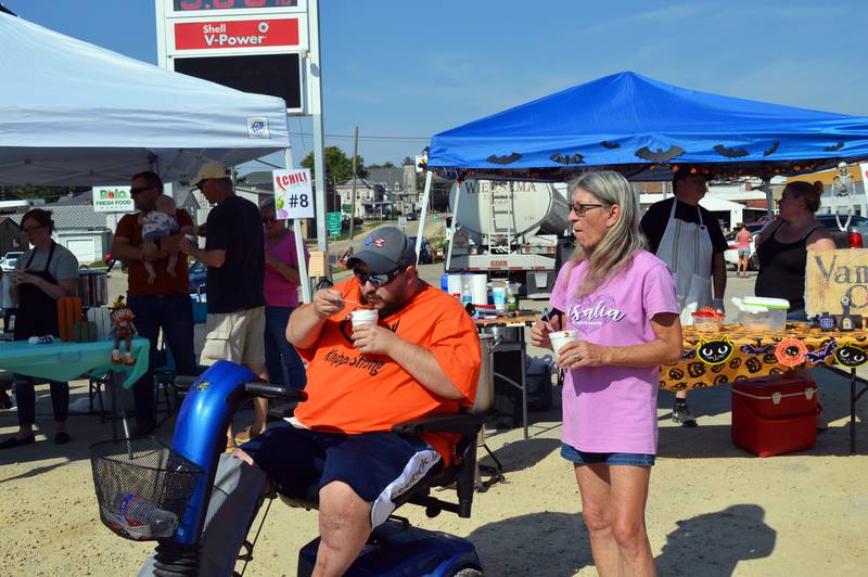 Tommy Knipple, left, and his mom, Edie Knipple, of Polo, enjoy bowls of chili during Polo's Chili Cook-Off on Sept. 30, 2023. The cook-off was held in the city-owned lot next to the Shell station; it was the first time the event has taken place since 2019.