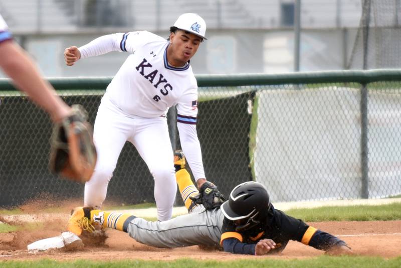 Kankakee's Bryce Arseneaux, left, applies a tag on Thornwood's Jaden Lee as Lee slides into third base during a game at Kankakee Thursday, April 17, 2025.