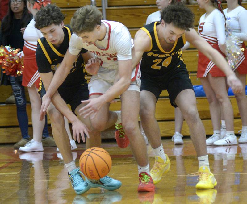 Reed Custer’s Ethan Segovia and Colton Waldvogel battle with Streator’s Riley Stevens for a loose ball in the 2nd period Tuesday at Streator.
