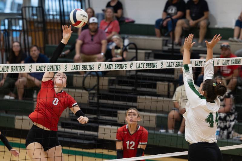 Grace Longmire (8) of Woodland spikes ball over net as Hanna Waszkowiak (44) of St. Bede jump to defend on Thursday, Sept. 11, 2025 at Abbot Vincent Gymnasium in Peru.