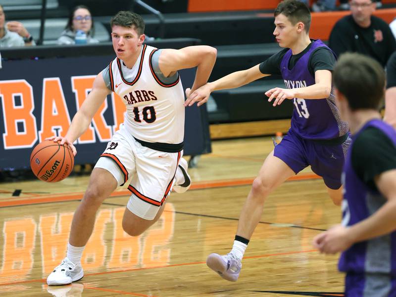 DeKalb’s Eric Rosenow drives around Dixon’s Cullen Shaner during their game Tuesday, Dec. 12, 2023, at DeKalb High School.