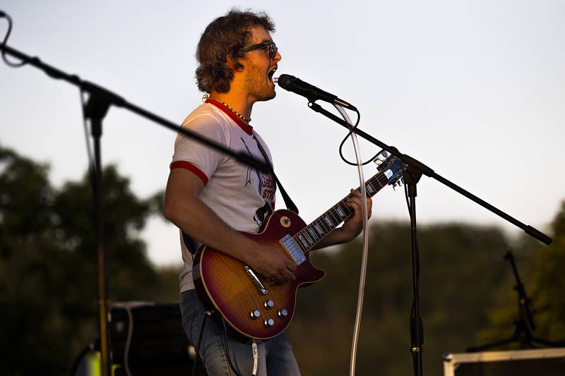 Dayton Reuter of local rock band The Solution, belts out some lyrics Thursday, June 19, 2025, during the Rock Falls Block Party. The band played on the stage at RB&W Park as the burnout show came to a close.