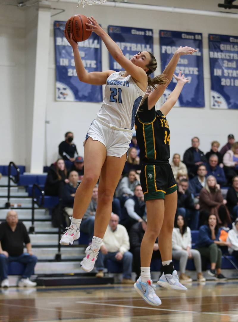 Nazareth's Olivia Austin (21) goes up to the basket during the girls varsity basketball game between Fremd and Nazareth on Monday, Jan. 9, 2023 in La Grange Park, IL.